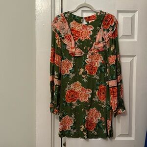 A green-and-pink flora print patterning on this breezy dress